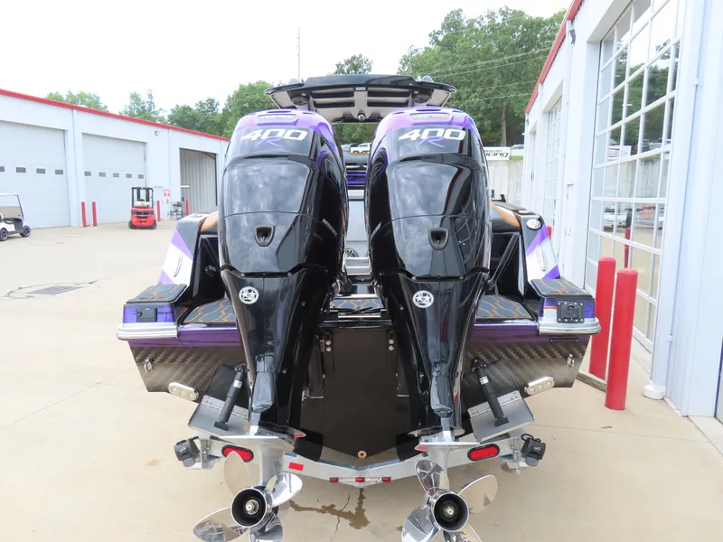 Slide: The Image of 2023 Sunsation 32 CCX boat with dual 400 horsepower engines, parked at a marina. - 6