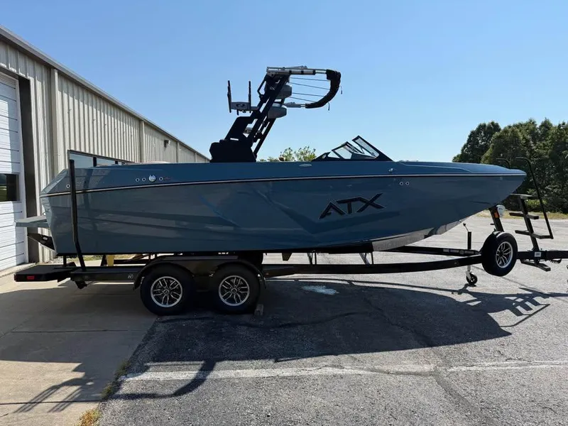 Slide: The Image of 2026 ATX Surf Boats 22 Type-S on trailer, parked outside a building. - 4