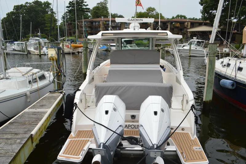 Slide: The Image of 2023 Tiara Yachts 34 LS docked, featuring dual outboard engines and spacious seating. - 11