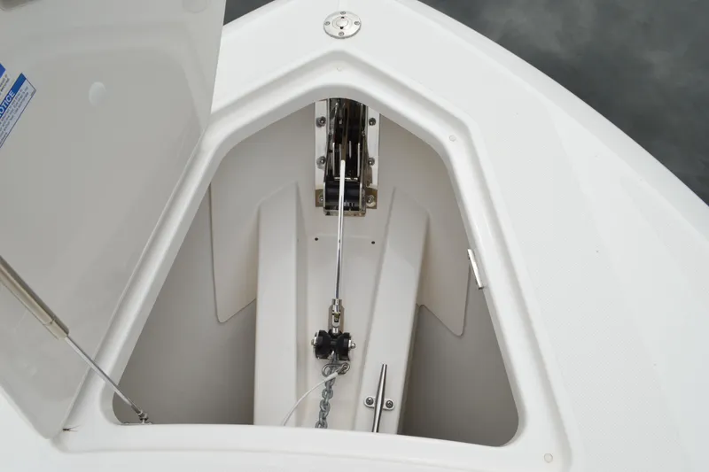 Slide: The Image of 2023 Tiara Yachts 34 LS anchor locker with open hatch and chain mechanism. - 18