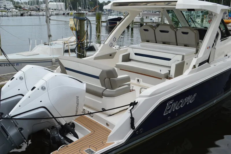 Slide: The Image of 2023 Tiara Yachts 34 LS with dual Mercury engines docked at a marina. - 20