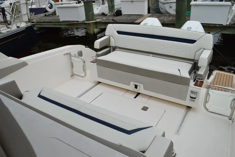 Slide: The Image of 2023 Tiara Yachts 34 LS interior with white seating and dock view. - 21