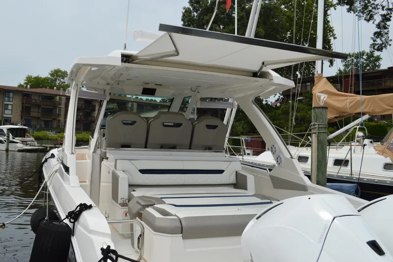 Slide: The Image of 2023 Tiara Yachts 34 LS luxury boat docked, featuring spacious seating and modern design. - 24