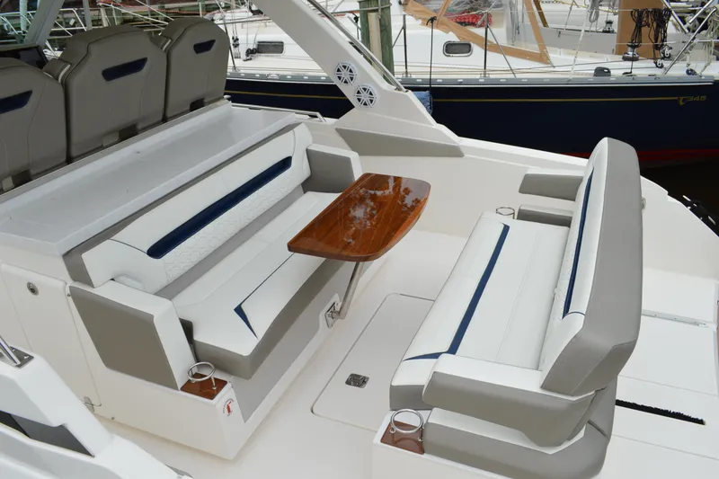 Slide: The Image of 2023 Tiara Yachts 34 LS interior with elegant seating and wooden table. - 29