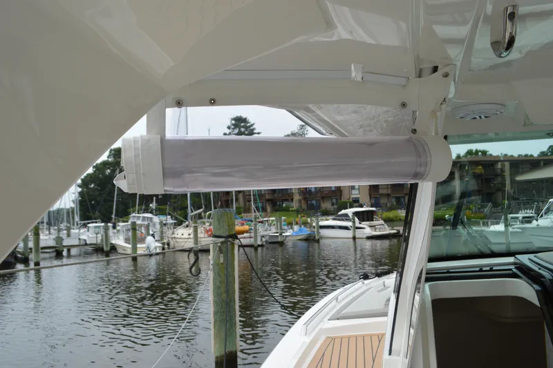 Slide: The Image of 2023 Tiara Yachts 34 LS, featuring a sleek design at a marina. - 34