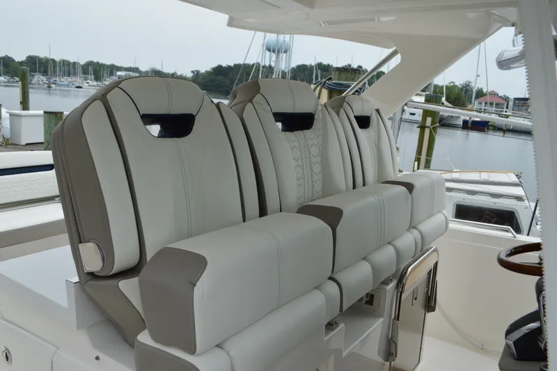 Slide: The Image of 2023 Tiara Yachts 34 LS boat seats, luxurious design, docked at marina. - 36