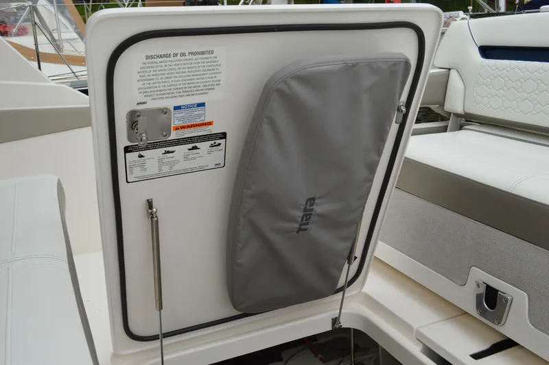 Slide: The Image of 2023 Tiara Yachts 34 LS interior detail with storage compartment and safety warnings. - 43