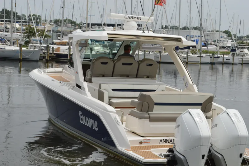 Slide: The Image of 2023 Tiara Yachts 34 LS boat docked, featuring dual Mercury engines. - 7