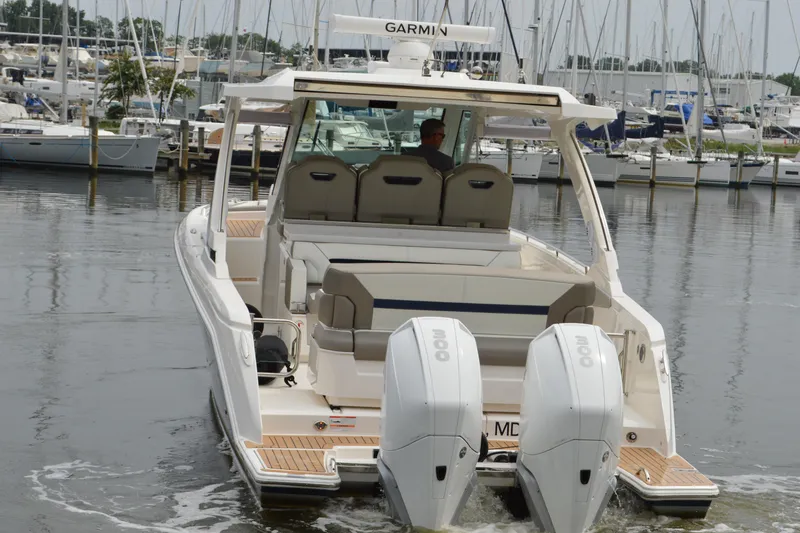 Slide: The Image of 2023 Tiara Yachts 34 LS with dual engines, docked in a marina. - 8