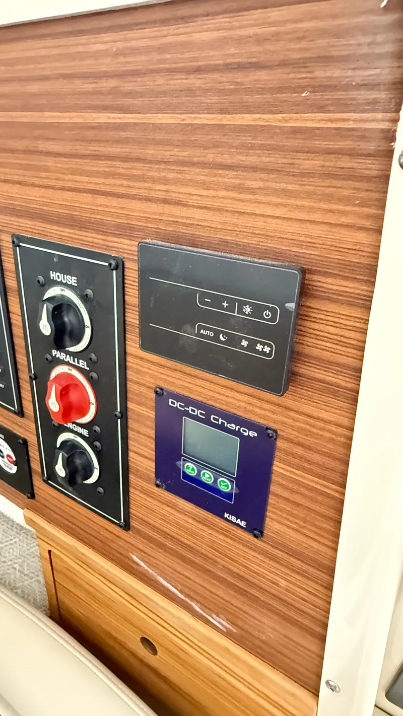 Slide: The Image of Control panel of 2026 Ranger Tugs R-27 with DC-DC charge display and switches. - 31