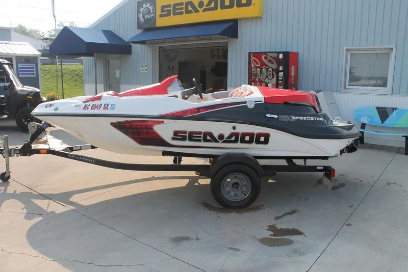 Slide: The Image of 2007 Sea-Doo Speedster 150 jet boat on trailer outside dealership. - 5