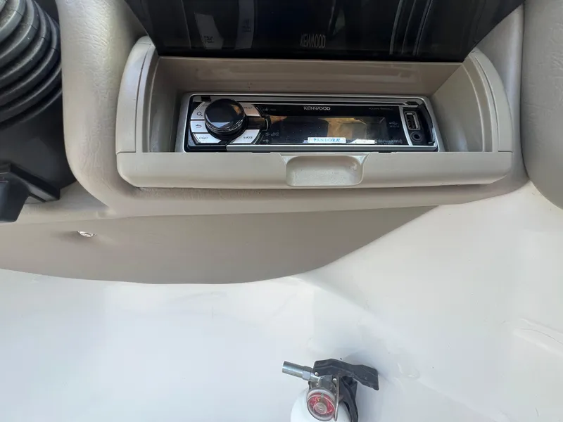 Slide: The Image of Kenwood stereo system in 2006 Crownline 270 BR boat dashboard. - 14