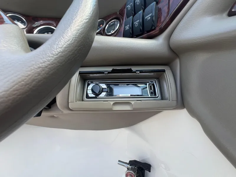 Slide: The Image of 2006 Crownline 270 BR dashboard with Kenwood stereo system and control switches. - 15