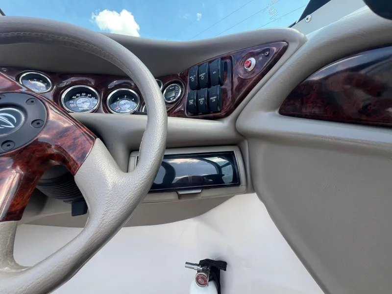 Slide: The Image of 2006 Crownline 270 BR dashboard with gauges, switches, and steering wheel. - 16