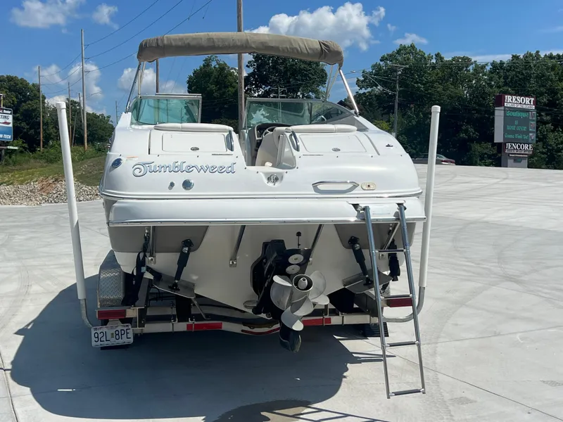 Slide: The Image of 2006 Crownline 270 BR boat on trailer, rear view with ladder and propeller, outdoors. - 2