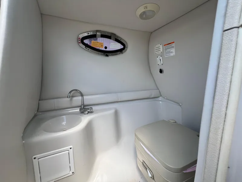 Slide: The Image of 2006 Crownline 270 BR boat interior bathroom with sink and toilet. - 21