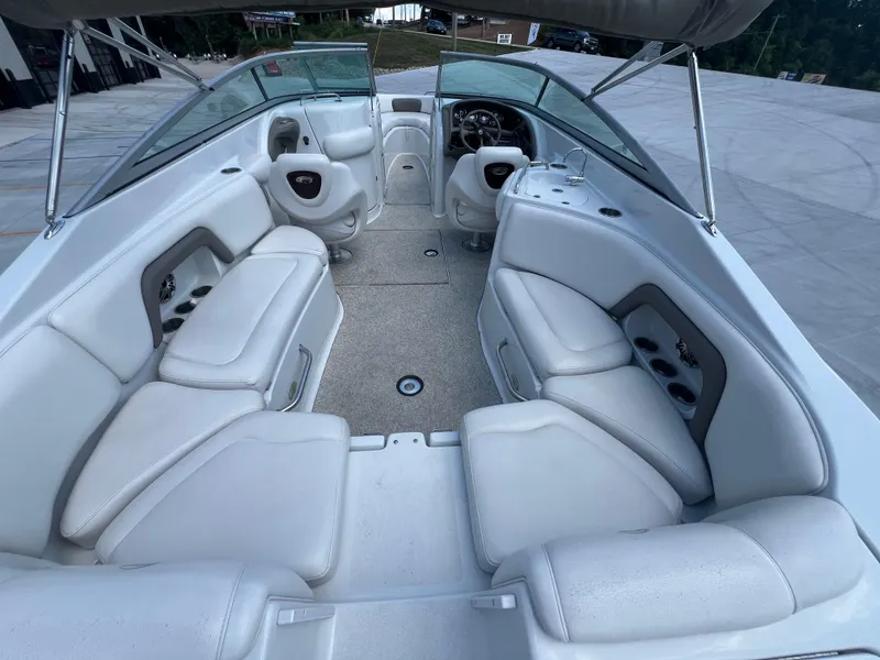 Slide: The Image of 2006 Crownline 270 BR boat interior with white seating and steering console. - 25
