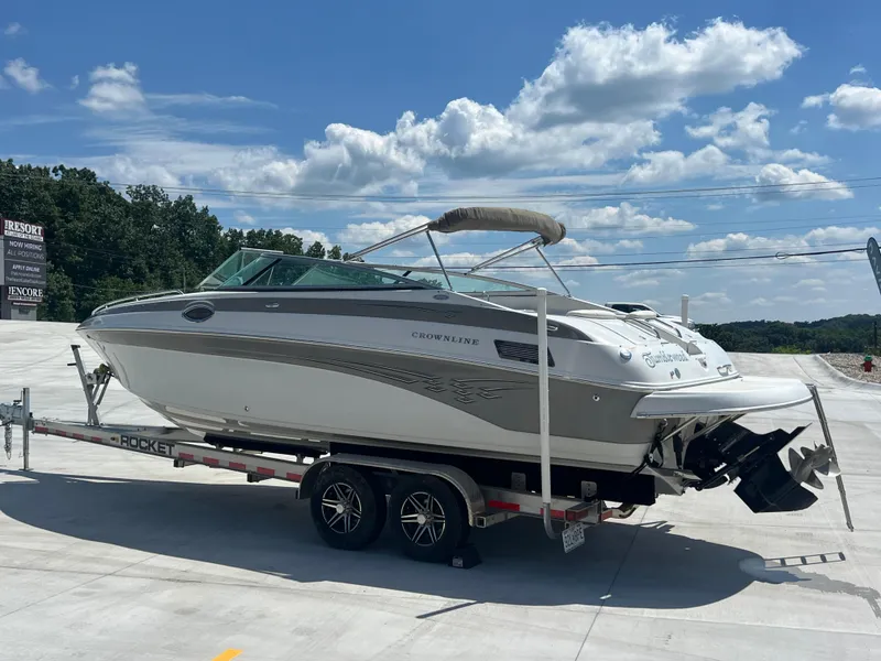 Slide: The Image of 2006 Crownline 270 BR boat on trailer under a clear blue sky. - 3