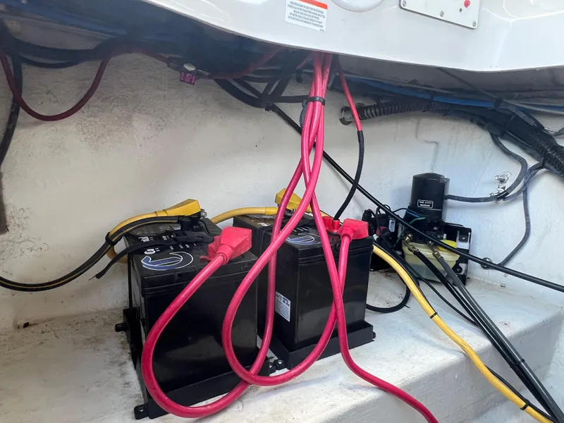 Slide: The Image of Battery compartment of a 2006 Crownline 270 BR boat with red and yellow cables. - 30