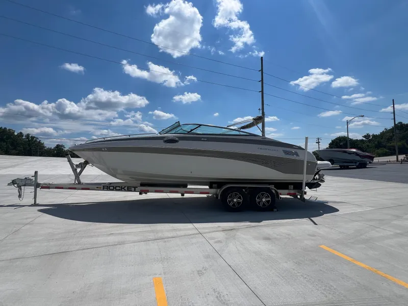 Slide: The Image of 2006 Crownline 270 BR boat on trailer under blue sky with clouds. - 4