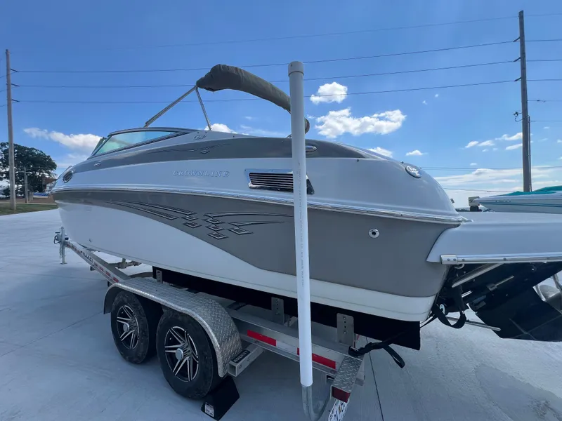 Slide: The Image of 2006 Crownline 270 BR boat on trailer under clear blue sky. - 6