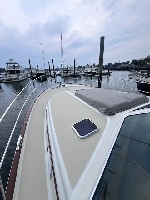 Slide: The Image of 2021 Sabre 45 Salon Express yacht docked at marina, overcast sky. - 13
