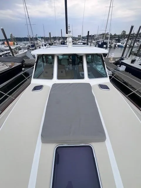 Slide: The Image of 2021 Sabre 45 Salon Express yacht docked at marina, showcasing sleek design and spacious deck. - 14