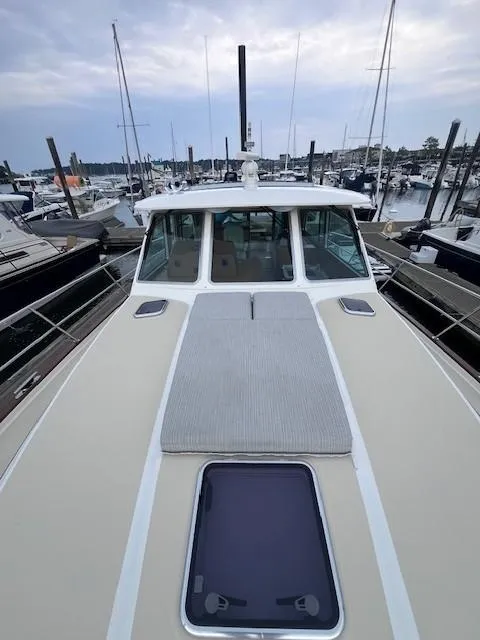 Slide: The Image of 2021 Sabre 45 Salon Express yacht docked at marina, showcasing sleek deck design. - 15