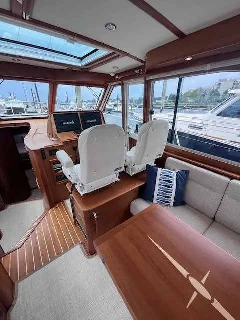 Slide: The Image of Interior of 2021 Sabre 45 Salon Express yacht with helm and seating area. - 24