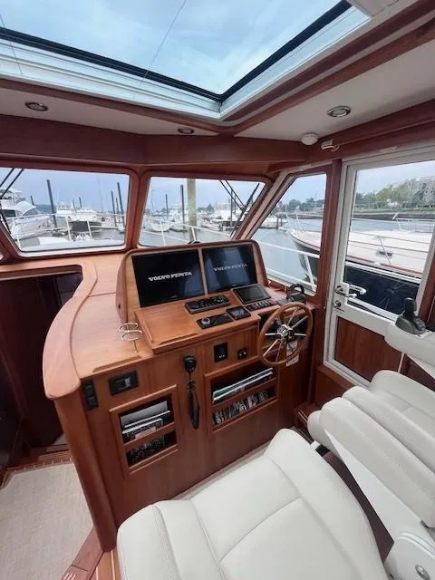 Slide: The Image of Interior of 2021 Sabre 45 Salon Express yacht with modern helm and panoramic windows. - 25