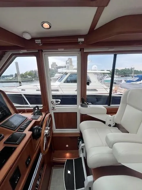 Slide: The Image of Interior view of 2021 Sabre 45 Salon Express yacht cockpit with white captain's chair. - 26