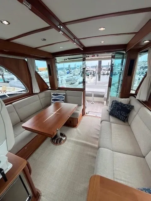 Slide: The Image of 2021 Sabre 45 Salon Express interior with elegant seating and wooden accents. - 28