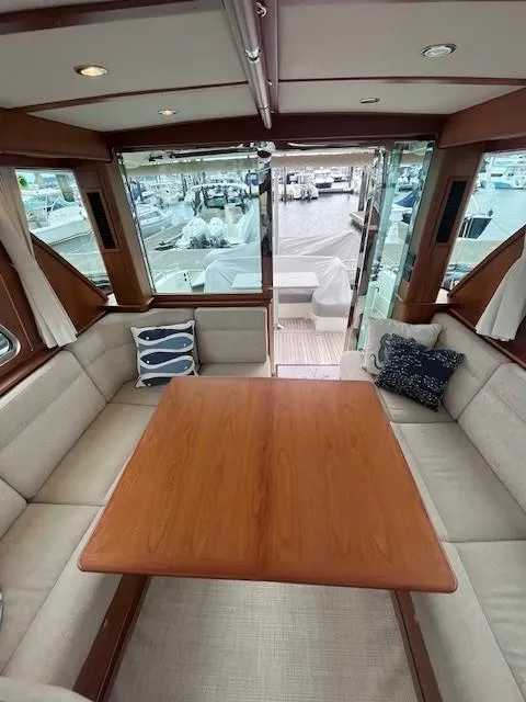 Slide: The Image of 2021 Sabre 45 Salon Express interior with elegant wood table and plush seating. - 29