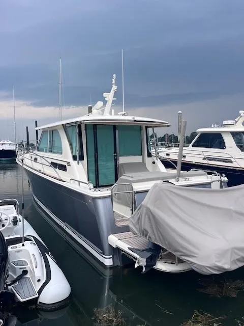Slide: The Image of 2021 Sabre 45 Salon Express yacht docked in a marina under cloudy skies. - 3