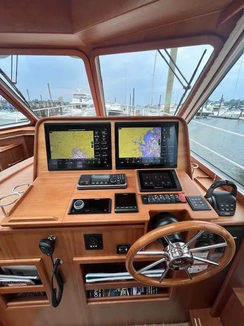 Slide: The Image of 2021 Sabre 45 Salon Express helm with dual navigation screens and wooden steering wheel. - 30