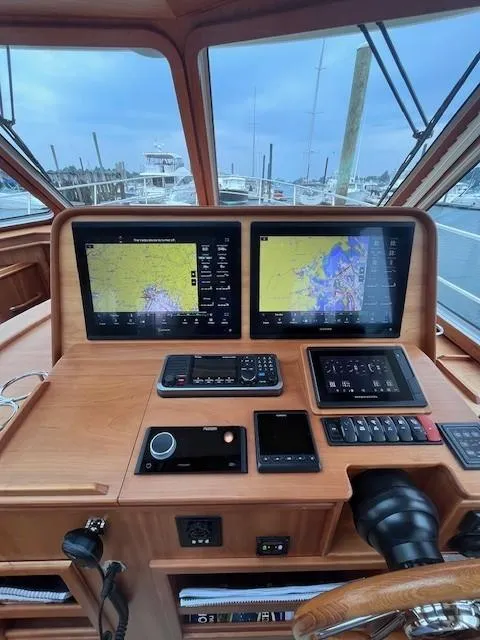 Slide: The Image of 2021 Sabre 45 Salon Express helm with dual navigation screens and control panel. - 31