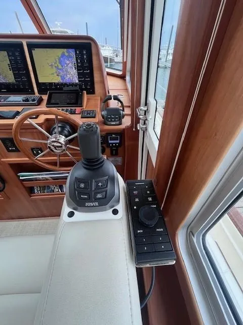 Slide: The Image of 2021 Sabre 45 Salon Express helm with joystick control and navigation screens. - 32