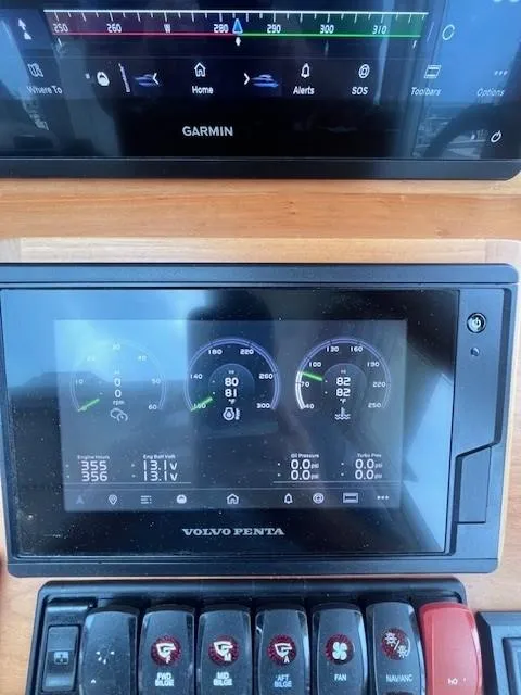 Slide: The Image of Control panel of a 2021 Sabre 45 Salon Express with Garmin and Volvo Penta displays. - 33