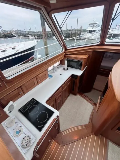 Slide: The Image of 2021 Sabre 45 Salon Express yacht interior with wooden cabinetry and modern kitchen appliances. - 38