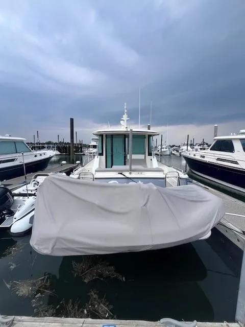 Slide: The Image of 2021 Sabre 45 Salon Express yacht docked at marina under cloudy sky. - 4