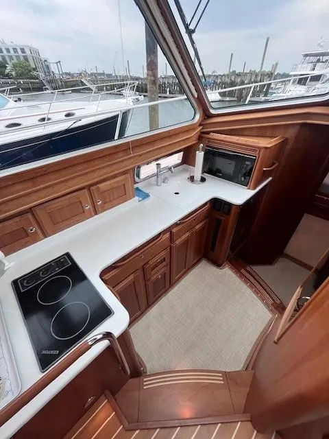 Slide: The Image of 2021 Sabre 45 Salon Express yacht kitchen with wood cabinetry and modern appliances. - 40