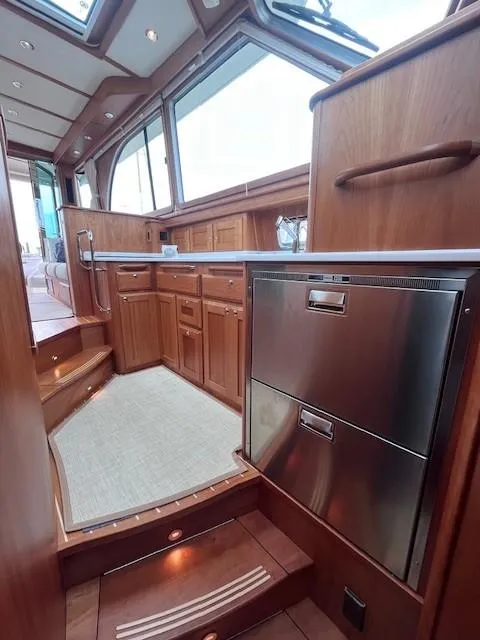 Slide: The Image of Interior of 2021 Sabre 45 Salon Express yacht with wooden cabinetry and stainless steel appliances. - 41