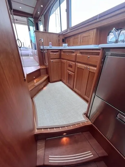 Slide: The Image of 2021 Sabre 45 Salon Express interior with wooden cabinetry and modern kitchen appliances. - 42