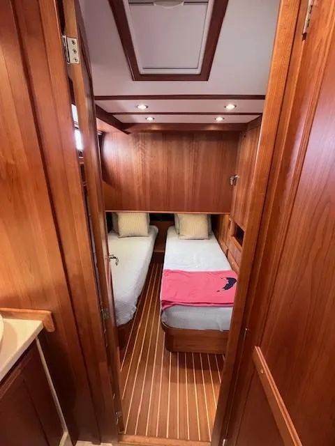 Slide: The Image of 2021 Sabre 45 Salon Express cabin with twin beds and wooden interior. - 47