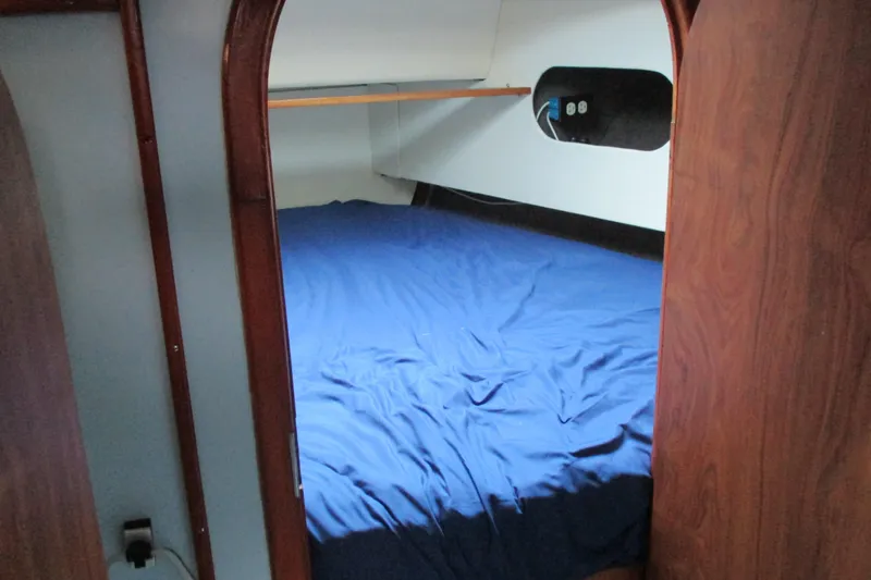 Slide: The Image of Cozy cabin interior of 1978 Moody 33 MkI sailboat with blue bedding. - 14