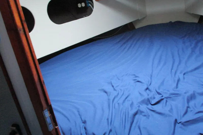 Slide: The Image of Cozy cabin interior of 1978 Moody 33 MkI sailboat with blue bedding. - 15
