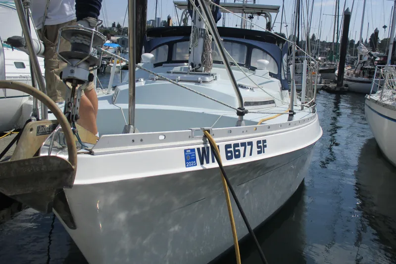 Slide: The Image of 1978 Moody 33 MkI sailboat docked in marina, front view with registration number visible. - 3