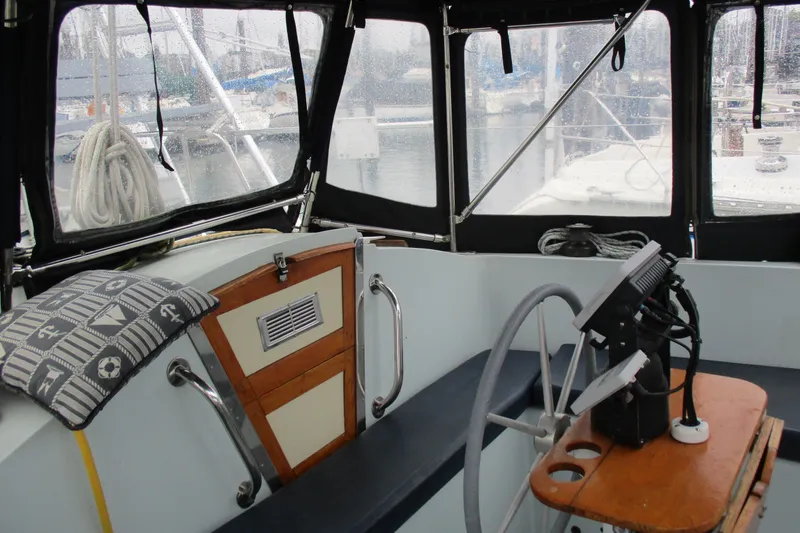 Slide: The Image of Interior of a 1978 Moody 33 MkI sailboat cockpit with steering wheel and navigation equipment. - 4