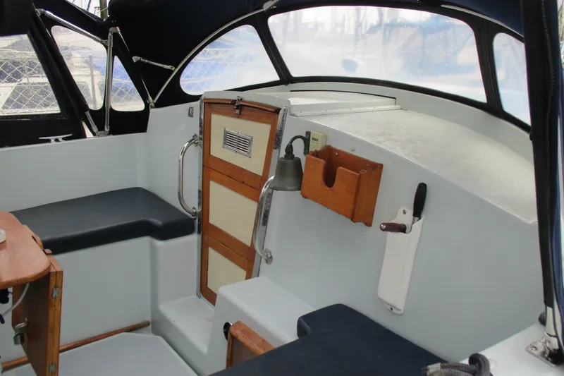 Slide: The Image of 1978 Moody 33 MkI yacht cockpit with seating, wooden accents, and nautical equipment. - 5