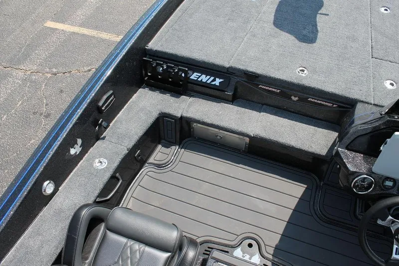 Slide: The Image of 2026 Phoenix 20 XE boat interior with gray carpet and black seating. - 6
